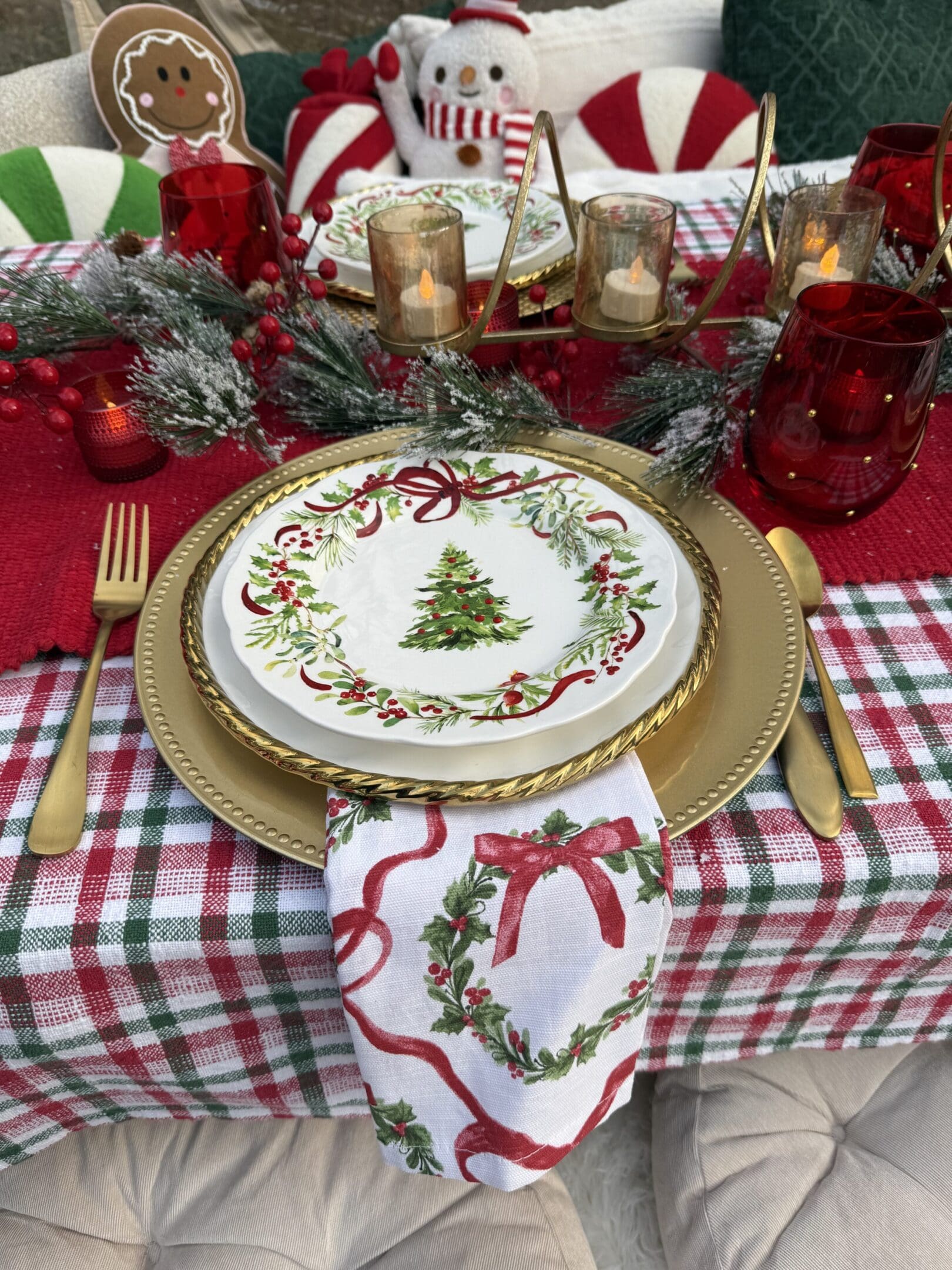 Festive Christmas table setting with tree-themed plates and holiday decorations.