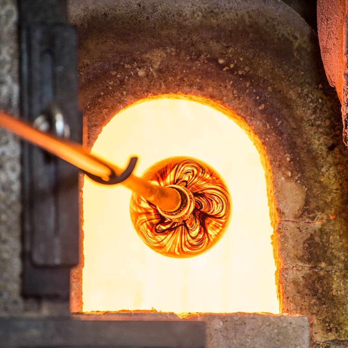 Hands-on glass blowing experience in Maine with molten glass shaping and artisan craftsmanship